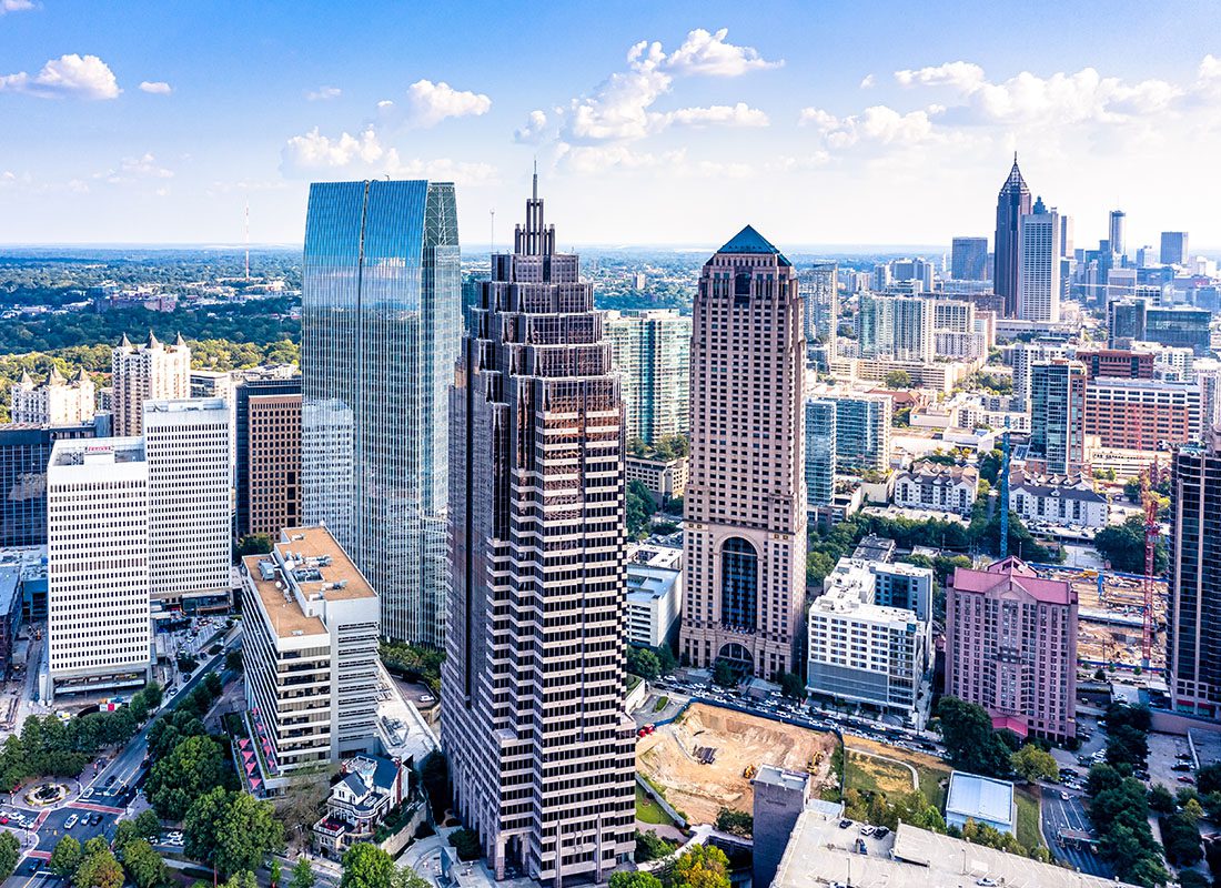 Atlanta, GA - Aerial View of Tall Skyscrapers and Other Commercial Buildings in Downtown Atlanta Georgia Against a Cloudy Blue Sky